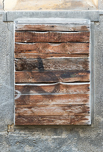 一堵旧的外墙砖墙，有一扇旧的木板窗，准备好了