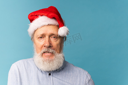 反对蓝色背景的阴沉的圣诞老人画象有拷贝空间蓝色背景。