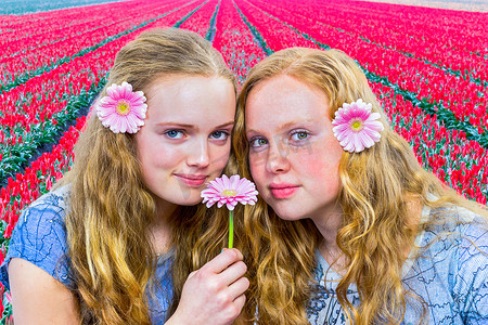 儿童培育摄影照片_红色郁金香田前的两个女孩