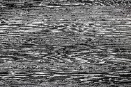 木质黑色表面的深灰色纹理，抽象的木质图案背景