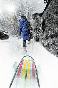 冬天雪地里暴风雪中的孩子拉着雪橇行走创意照片