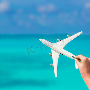 绿松石海背景下飞机的白色小缩影