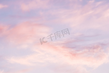 蓝天背景，日落时有白色和粉红色的云彩