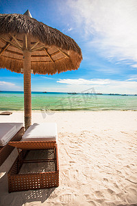 伞海滩摄影照片_在一个热带海滩的秸杆伞
