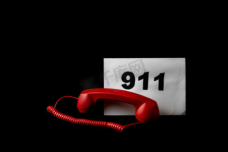 拨打急救电话摄影照片_拨打 911 和紧急呼叫概念，在纸上发短信 911，在黑色上隔离电话。
