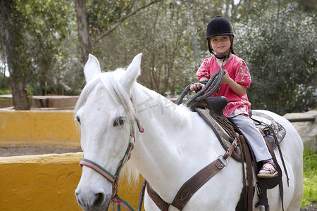 骑手小女孩骑师帽子白马在公园