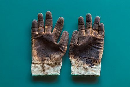 油渍摄影照片_孤立背景上带有油渍的手套。
