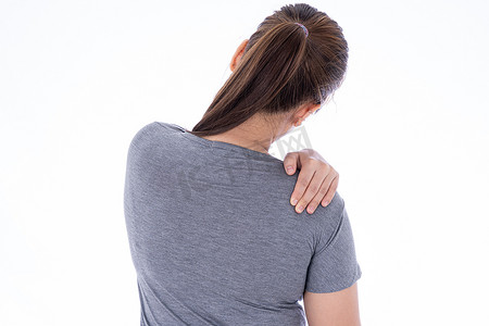 肩肌肉摄影照片_一个女人在孤立的白色背景下感到筋疲力尽，肩颈疼痛和受伤。