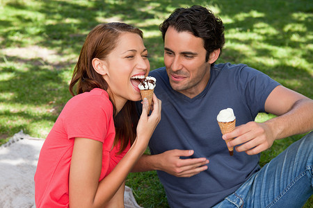 吃冰淇淋的女人摄影照片_和朋友坐在一起吃冰淇淋的女人