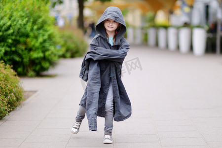有趣的小女孩穿着她父亲的外套