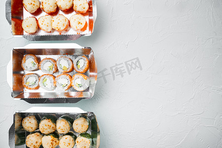 送餐盒中的一组寿司卷，白石背景，顶视图平躺，带有复制空间和文本空间