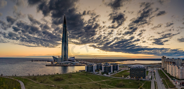 竣工验收摄影照片_俄罗斯，圣彼得堡，2020 年 5 月 6 日：日落时拉赫塔中心摩天大楼的空中全景图像，夜间照明亮起，它是欧洲最高的摩天大楼，竣工