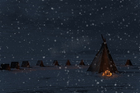 冬季降雪和带篝火的露营帐篷，夜光照片