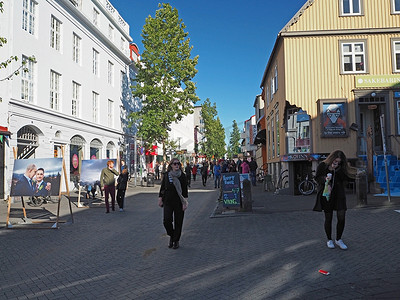 冰岛，雷克雅未克，2016 年 8 月 3 日：雷克雅未克市中心的主要街道，阳光明媚的日子里人们步行购物和玩乐