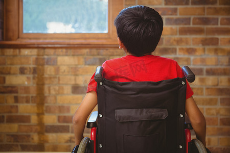 轮椅背面摄影照片_坐在轮椅上的男孩背面图