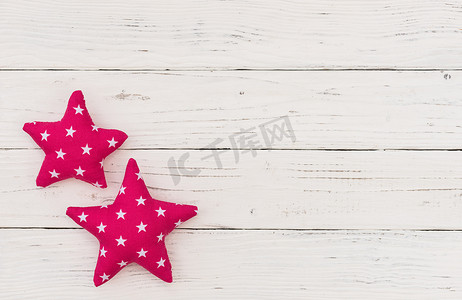 白色木制背景上可爱的粉红色星星
