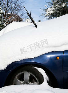 雨中汽车摄影照片_隐藏在雪中的汽车