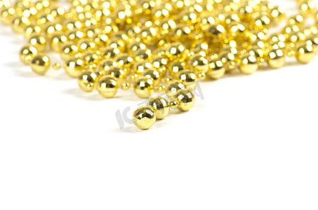 金色珠珠摄影照片_背景由金色的辉煌庆祝珠制成