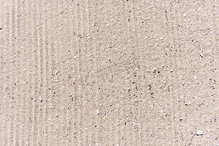 沙滩背景与清洁表面上的卡车痕迹
