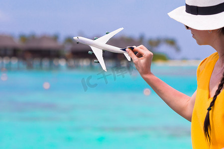 绿松石海女性手背景中的小白飞机模型