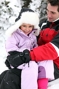 父亲和女儿在雪地里玩耍