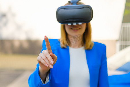 女商人通过在 VR 护目镜中用手指按下按钮来控制虚拟界面