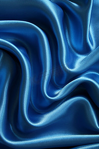 深蓝色布料摄影照片_光滑优雅的深蓝色丝绸可以用作背景