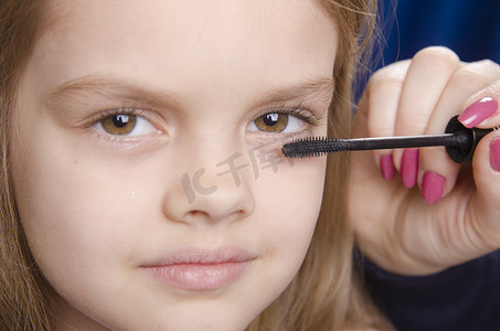 化妆师在女孩脸上画睫毛