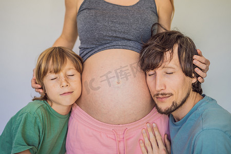 孕肚摄影照片_爸爸和大儿子听妈妈的孕肚