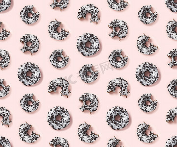 糕点海报摄影照片_粉红色背景顶视图上甜甜圈的优质无缝图案。