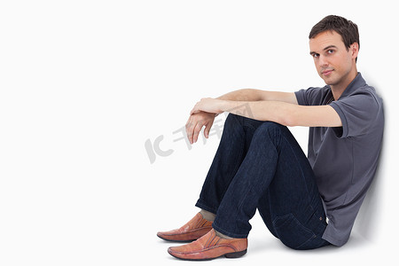 靠墙坐着的男人的特写