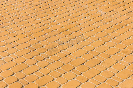 浅橙色或黄色石铺路砖地砖城市纹理背景