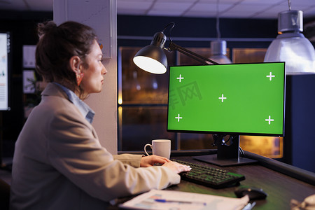 看着绿屏模拟色度键计算机的女商人