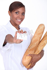 名片餐饮摄影照片_拿着法棍面包和一张空白名片的女面包师