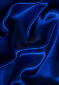 背景曲线蓝色摄影照片_光滑优雅的蓝色丝绸