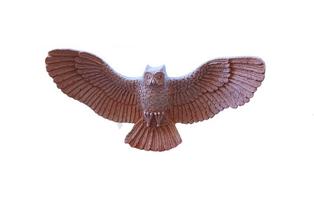 飞行猫头鹰摄影照片_飞行中的陶瓷猫头鹰