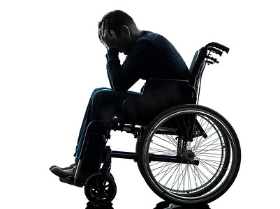 轮椅剪影中双手抱头的残疾人