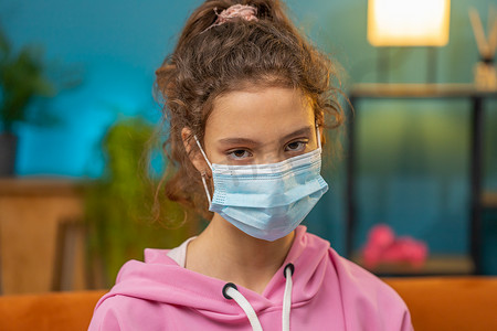 生病的女学生戴着医用防护面罩，看着相机、肺炎、过敏
