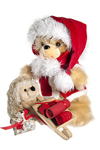 圣诞老人帽子摄影照片_带圣诞老人帽子和礼物的洋娃娃