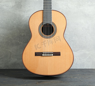 灰色背景下木桌上漂亮的六弦古典吉他