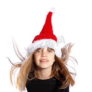 圣诞老人帽子的跳跃的圣诞节女孩