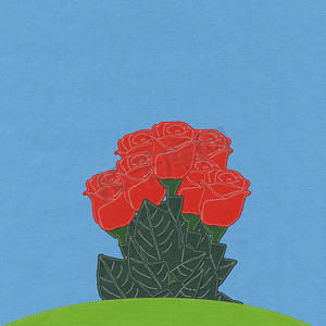 绿草地上的红玫瑰与针式织物背景