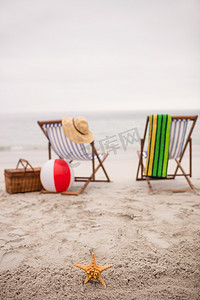 海洋星摄影照片_沙滩上空荡荡的躺椅和星鱼
