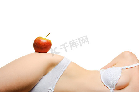 女性身材摄影照片_女性身材匀称和一个红苹果