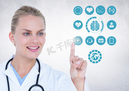 医疗图标数字化摄影照片_医生在白色背景下触摸数字生成的医疗图标