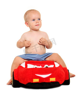 红色软玩具车里的小男孩