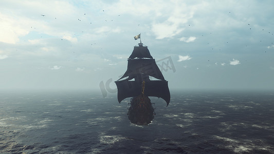旧旗摄影照片_一艘飘扬着海盗旗的旧海盗船在雾蒙蒙的清晨掠过大海。 