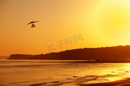 滑翔机在夕阳下飞翔