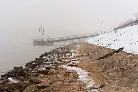 雾中肮脏的海岸，背景是码头