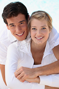 穿着白色衣服的年轻微笑夫妇
